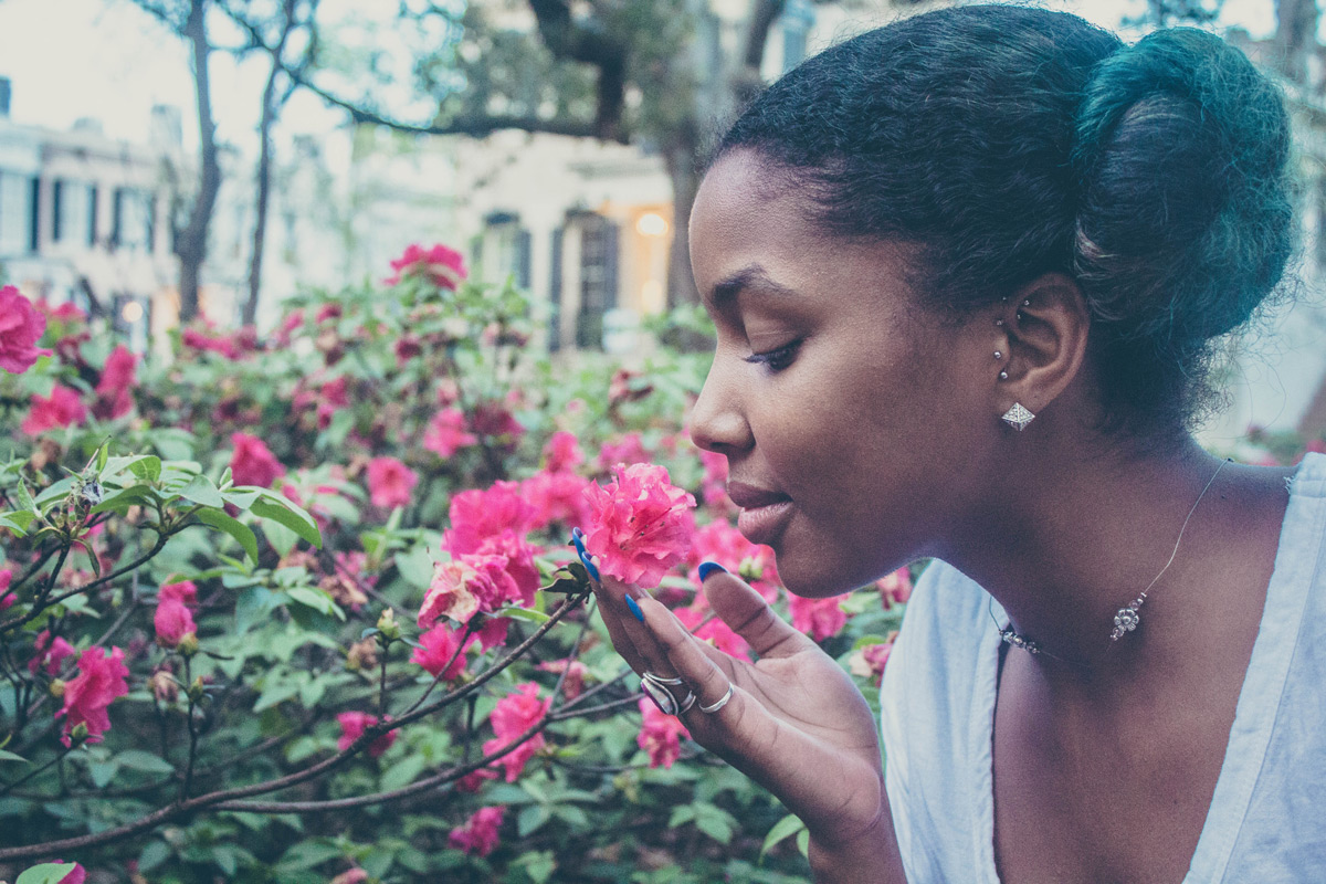 Woman smelling pink flowers